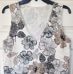 Knit top. Beaded neckline. Sleeveless. With tan, gray, black flower print.